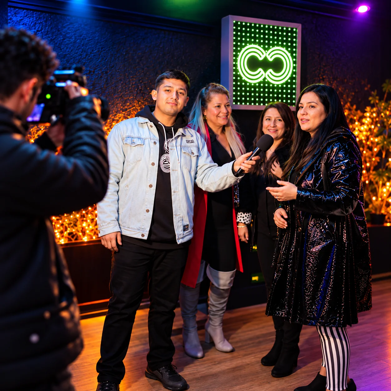 Equipo de Sin Guion entrevistando a invitados frente a cámara durante una fiesta